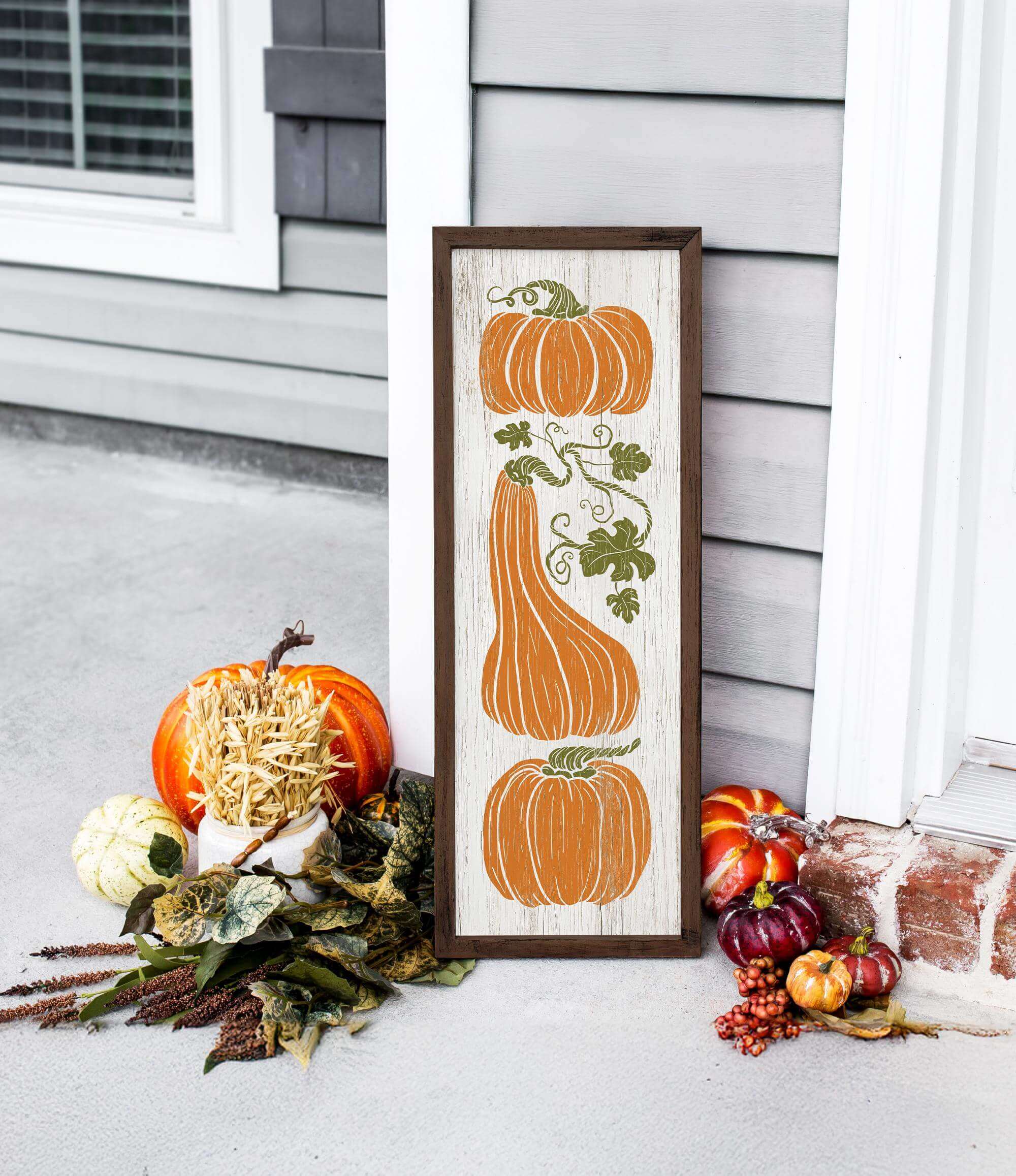 a picture of pumpkins and gourds on a porch