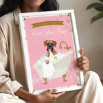 A woman is holding a framed poster with a cartoon image of a dog sitting in a bathtub, surrounded by bubbles.