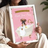 A woman is holding a framed poster with a cartoon image of a dog sitting in a bathtub, surrounded by bubbles.