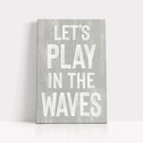 a wooden sign that says let&#39;s play in the waves