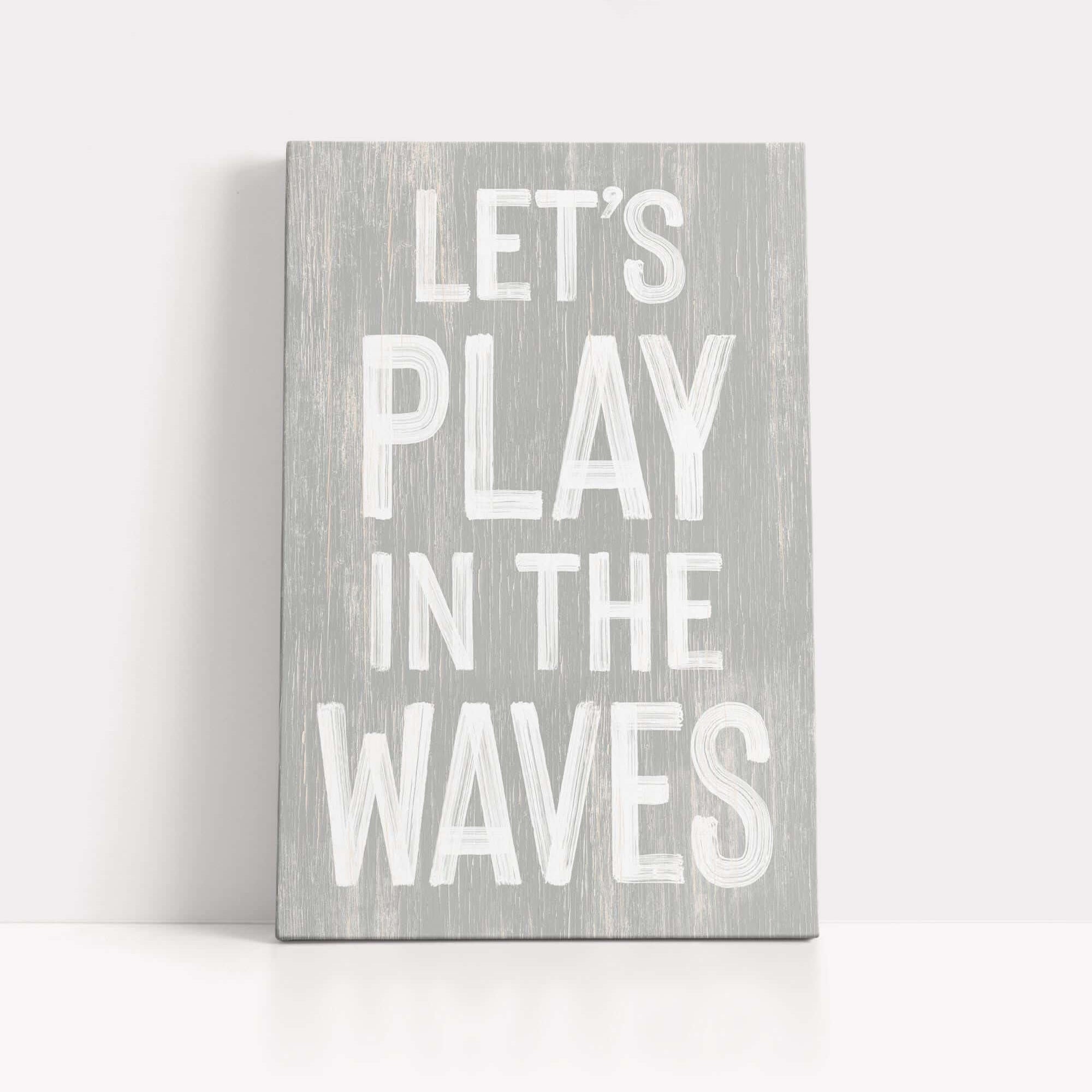a wooden sign that says let's play in the waves