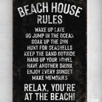 a sign on a wall that says beach house rules