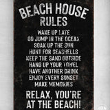 a sign on a wall that says beach house rules