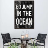 a table with two chairs and a sign that says go jump in the ocean