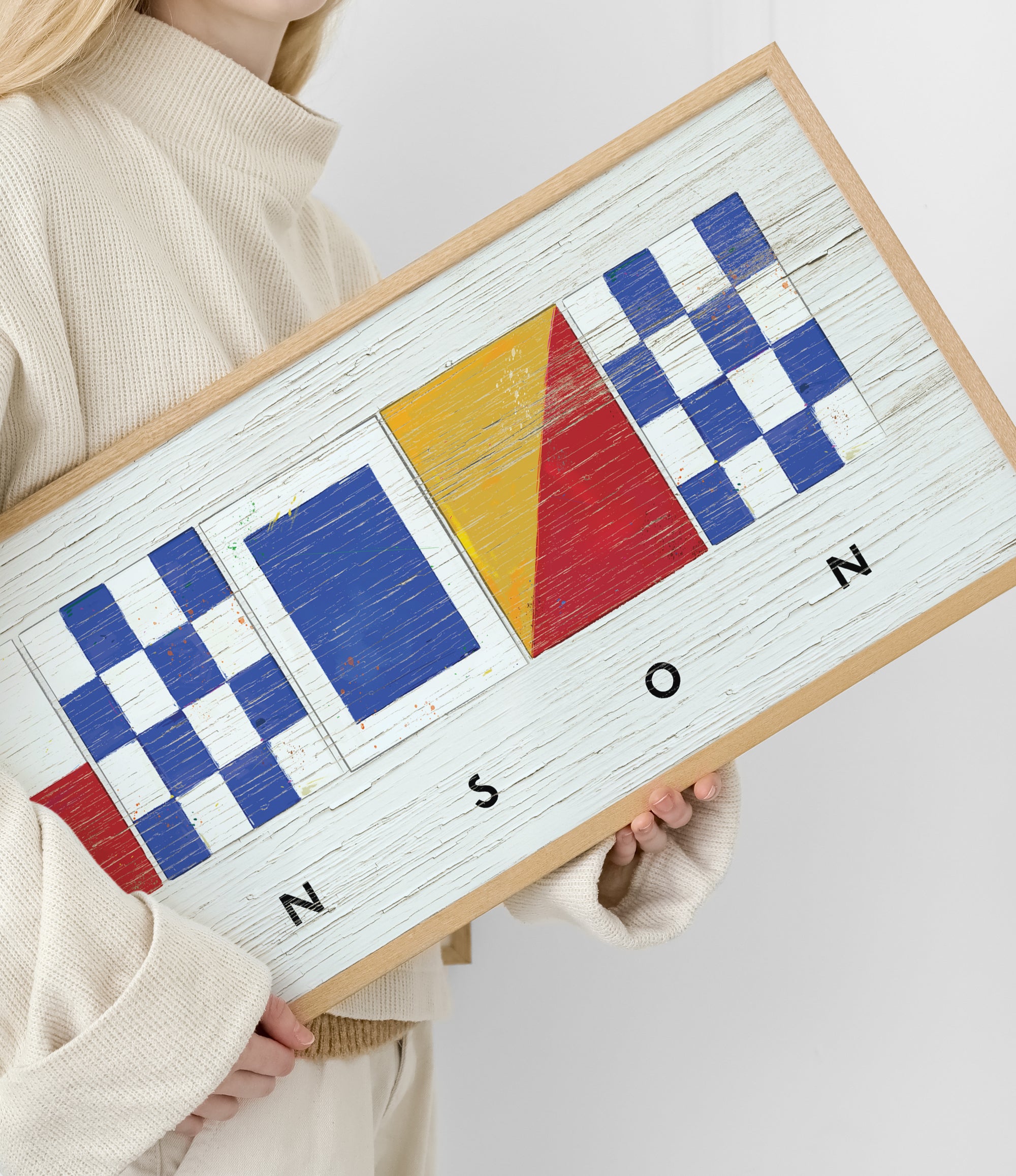 a woman holding a wooden sign with a design on it