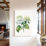 a living room with a large painting of a green and white hydrangea flower hanging on the wall.