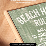 Close-up of the Beach House Rules Sign, featuring seagrass green painted wood with white text in a light wooden frame, displayed on a wooden surface—ideal coastal wall art for your beach house.