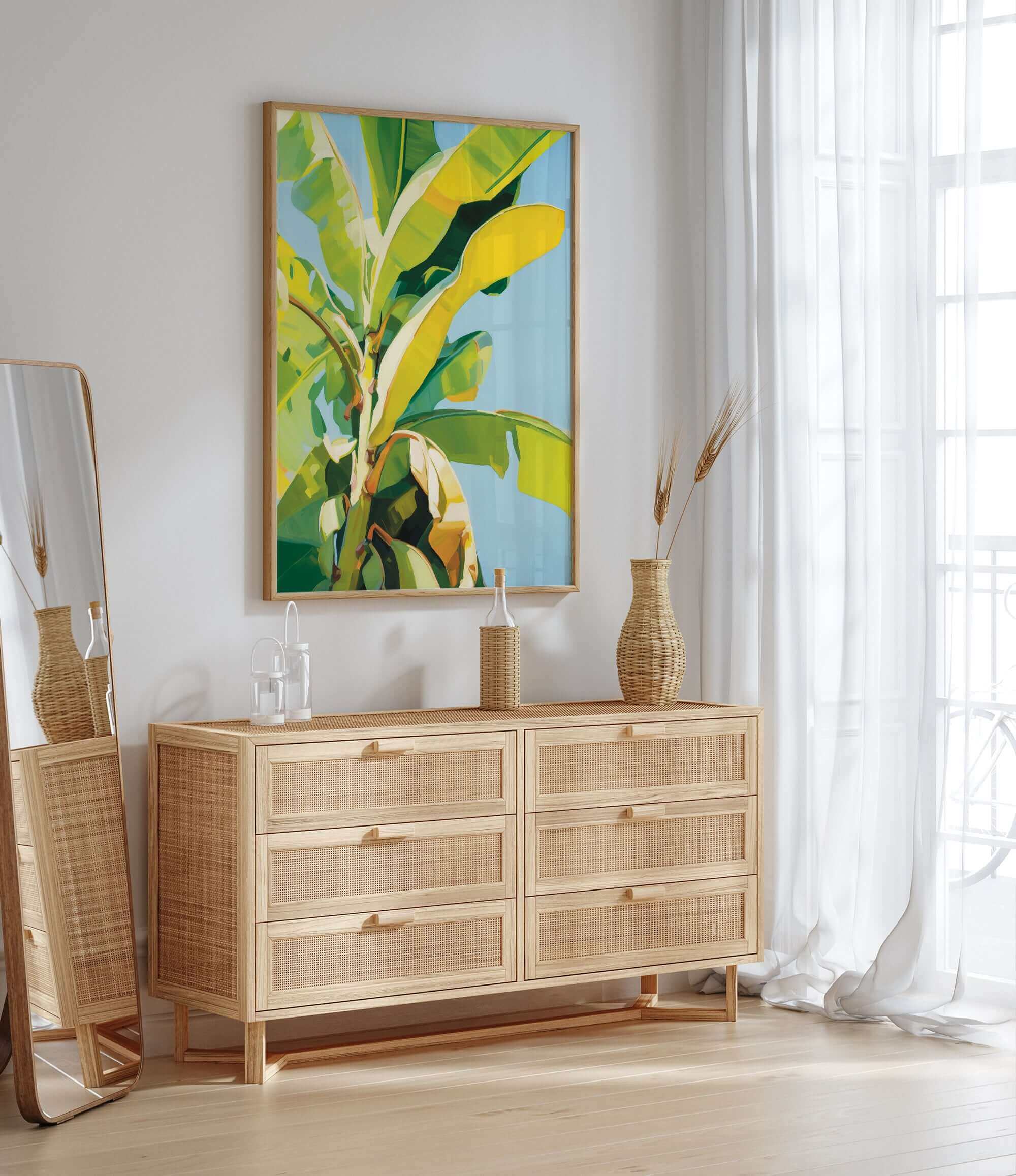a modern, minimalist interior design with a large, vibrant painting of a banana tree hanging on the wall above a wooden dresser with six drawers. The dresser has a woven vase and a bottle on top, adding a touch of natural elements to the space. The room is bright and airy, with a large window allowing natural light to flood in and a white curtain providing privacy.