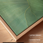 a close-up view of a canvas print with a natural frame, showcasing a vibrant green leaf design.