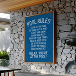 a pool rules sign on a stone wall