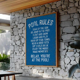 a pool rules sign on a stone wall