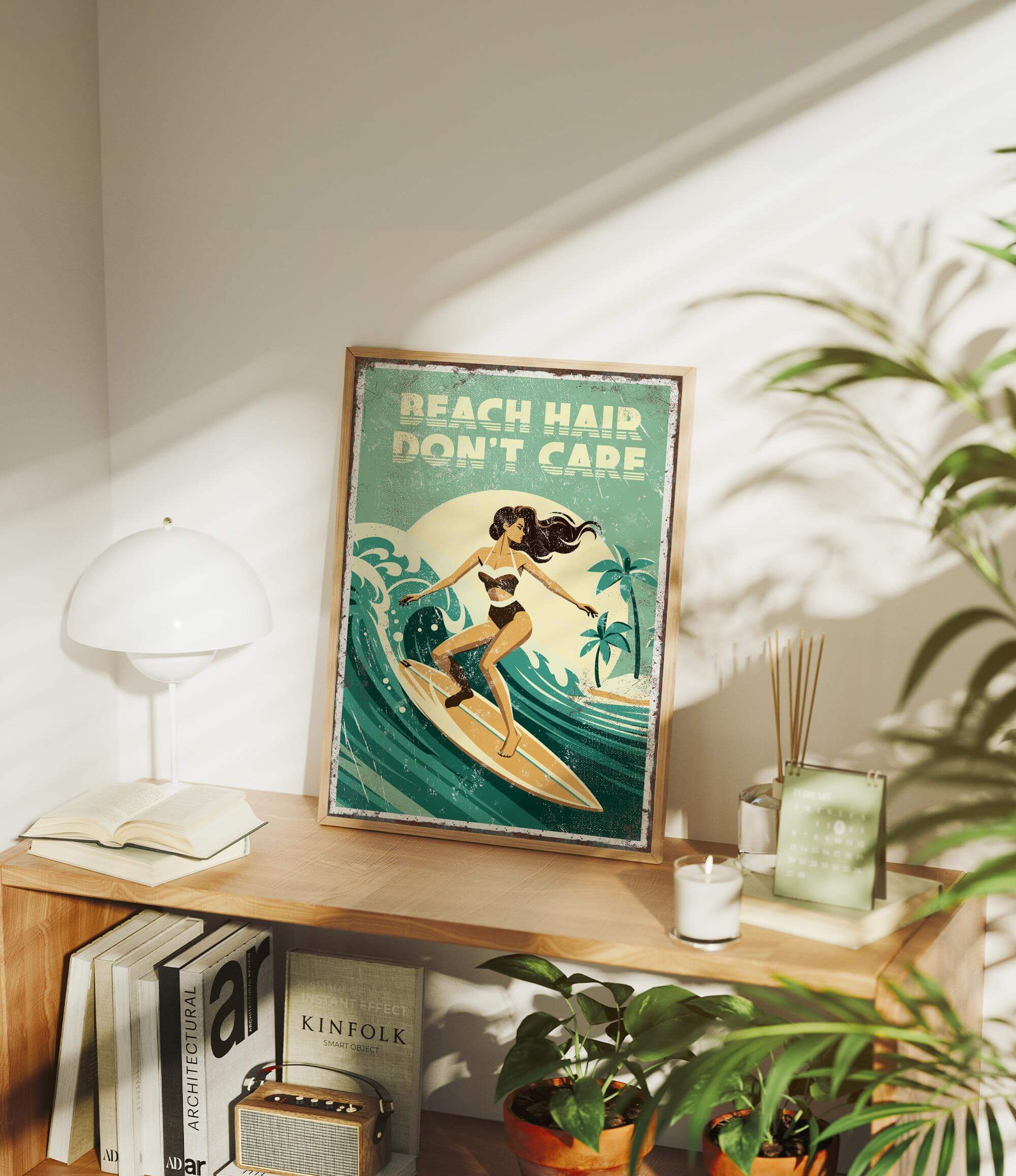 a framed poster of a woman surfing on a wave, with the text "BEACH HAIR DON'T CARE" written on it. The poster is displayed on a shelf, surrounded by various items such as books, plants, and a lamp.