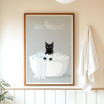 A framed poster with a black cat sitting in a white bathtub filled with bubbles, accompanied by the text "WASH YOUR PAWS" on the poster.