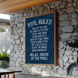 a pool rules sign on a stone wall