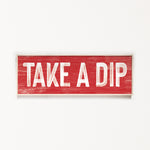 a red sign that says take a dip