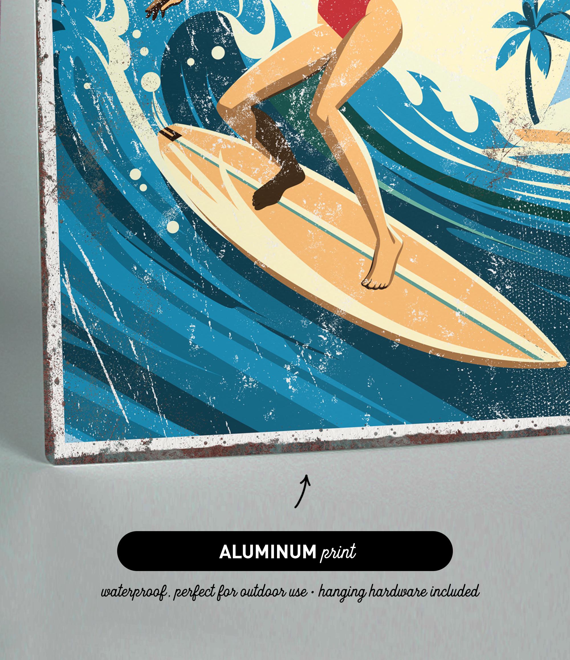 A woman is riding a surfboard on a wave in the ocean, with a palm tree and blue sky in the background.