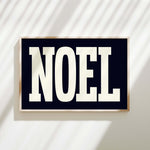 a black and white sign with the word noel on it