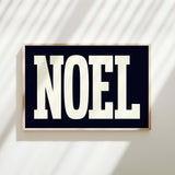 a black and white sign with the word noel on it