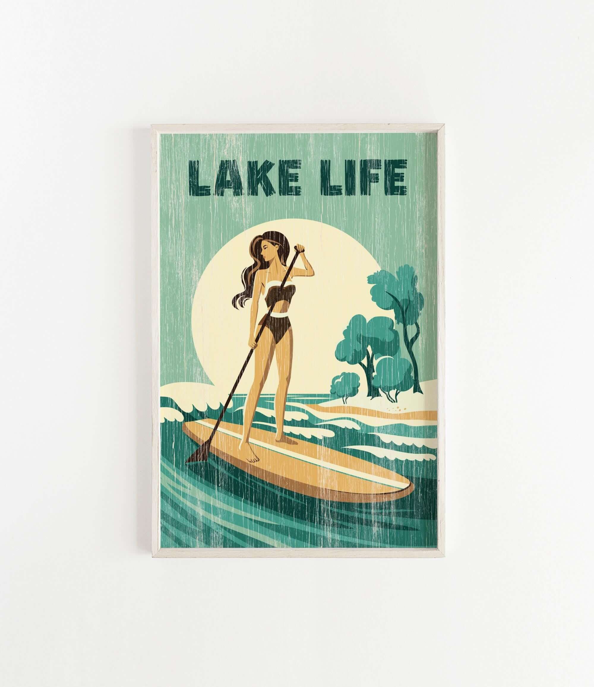 A woman in a bathing suit stands on a paddleboard, holding a paddle and facing a large body of water with trees in the background.