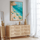 a beach scene with a painting of a beach and turquoise water, a wicker dresser with drawers, and a mirror on the wall.