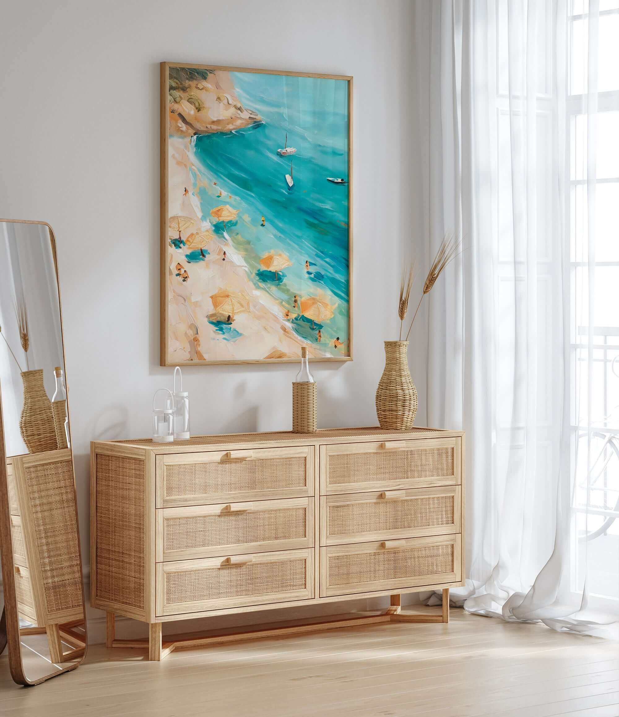 a beach scene with a painting of a beach and turquoise water, a wicker dresser with drawers, and a mirror on the wall.