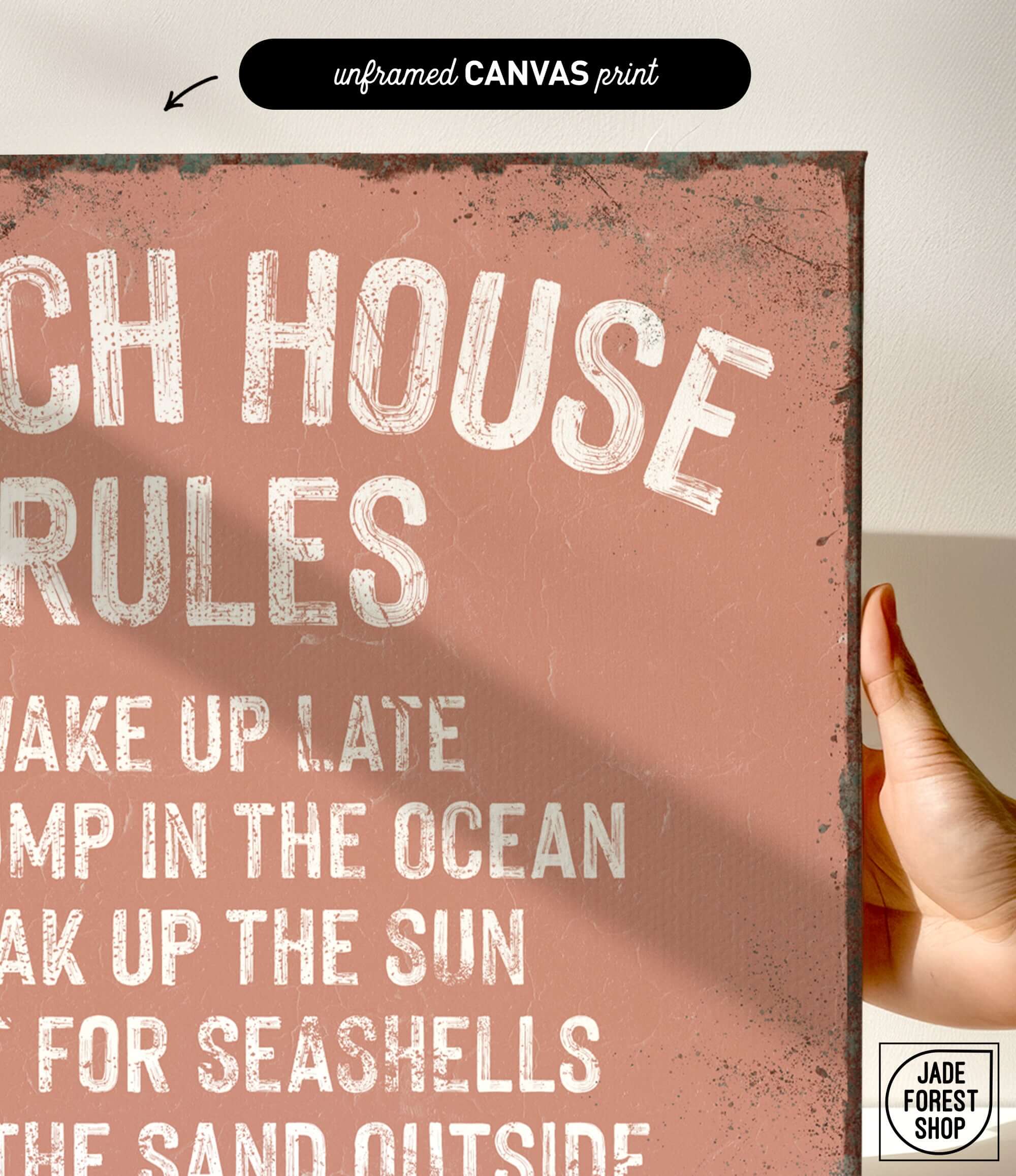 a hand holding a sign that says beach house rules