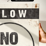 a hand holding a sign that says slow no wave