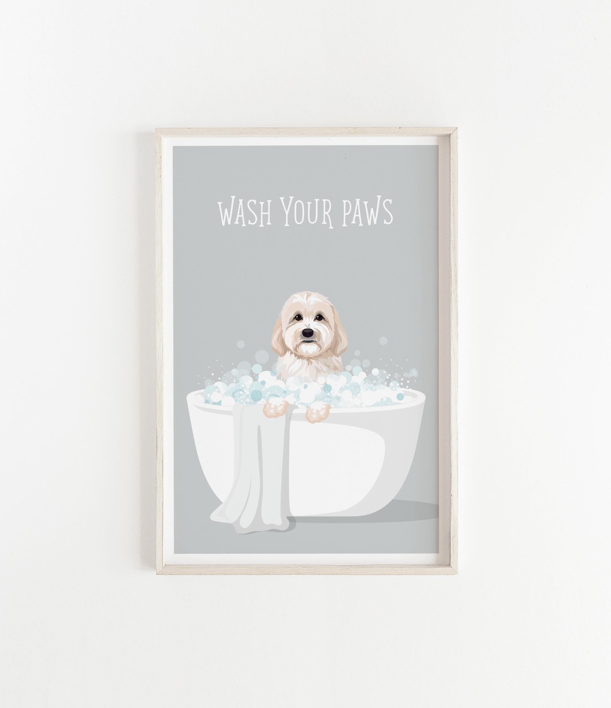 A framed illustration of a dog sitting in a bathtub filled with bubbles, with the text "WASH YOUR PAWS" displayed above it.