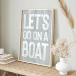 a sign that says let&#39;s go on a boat on a shelf