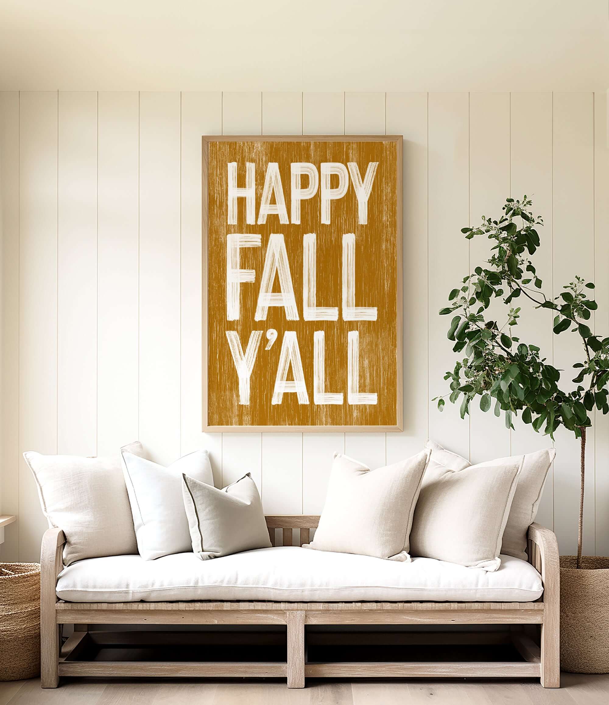 a living room with a white couch and a happy fall y'all sign