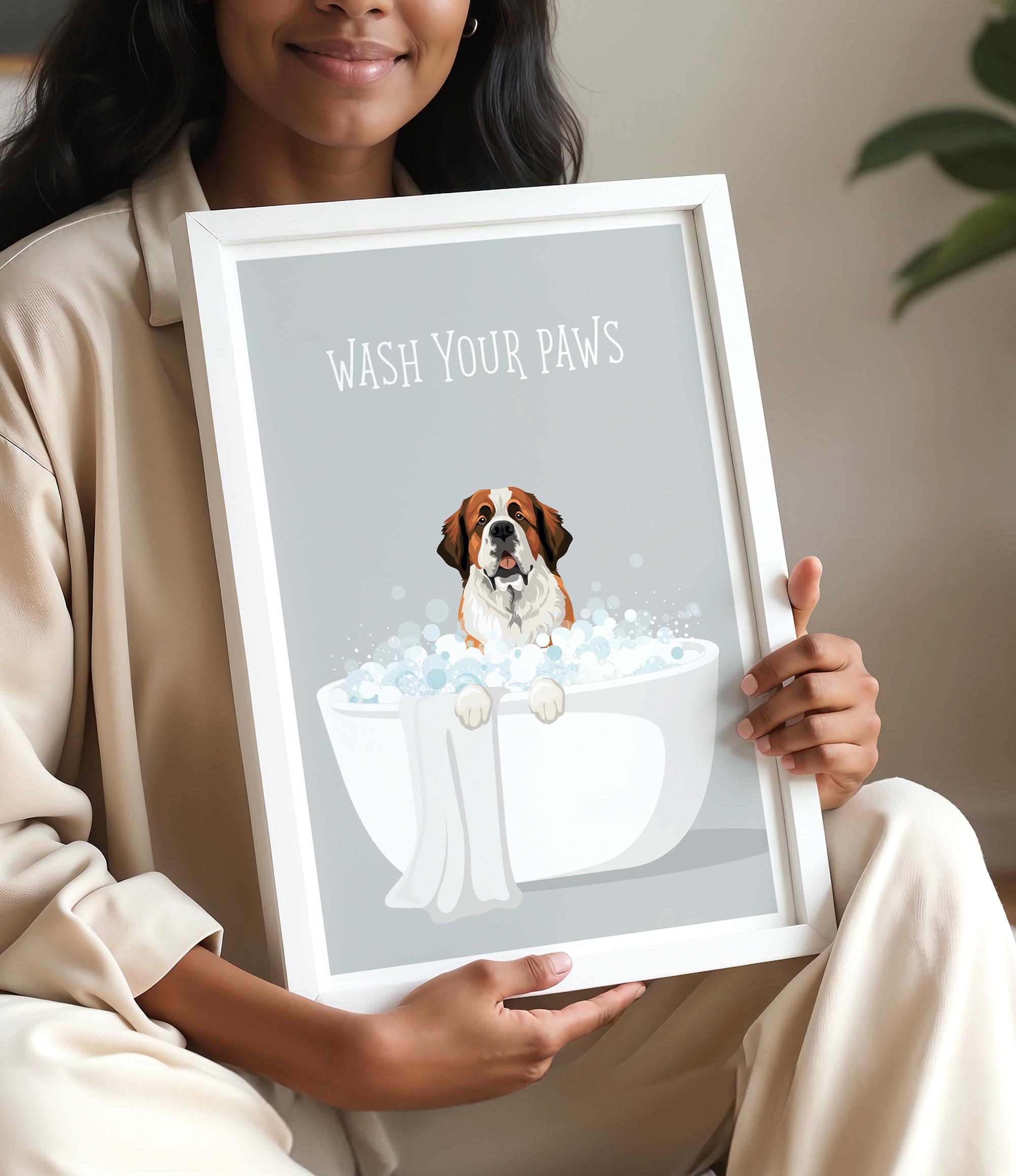 A woman is holding a framed picture with a dog sitting in a bathtub filled with bubbles, accompanied by the text "WASH YOUR PAWS".