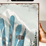a person holding up a picture of a pair of skis