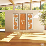 a living room with three pumpkins on the wall