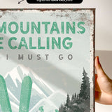 a hand holding a sign that says mountains are calling