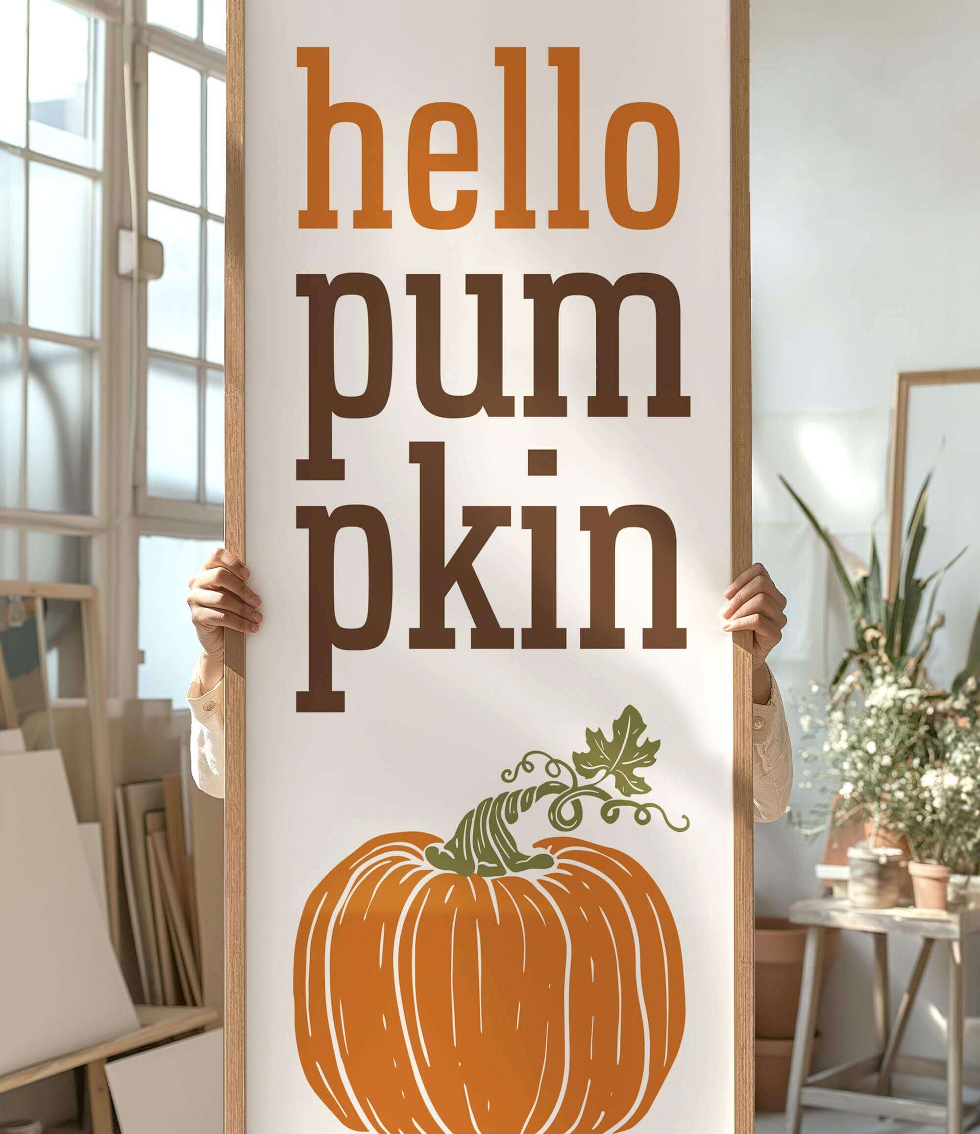 a person holding a sign that says hello pumpkin