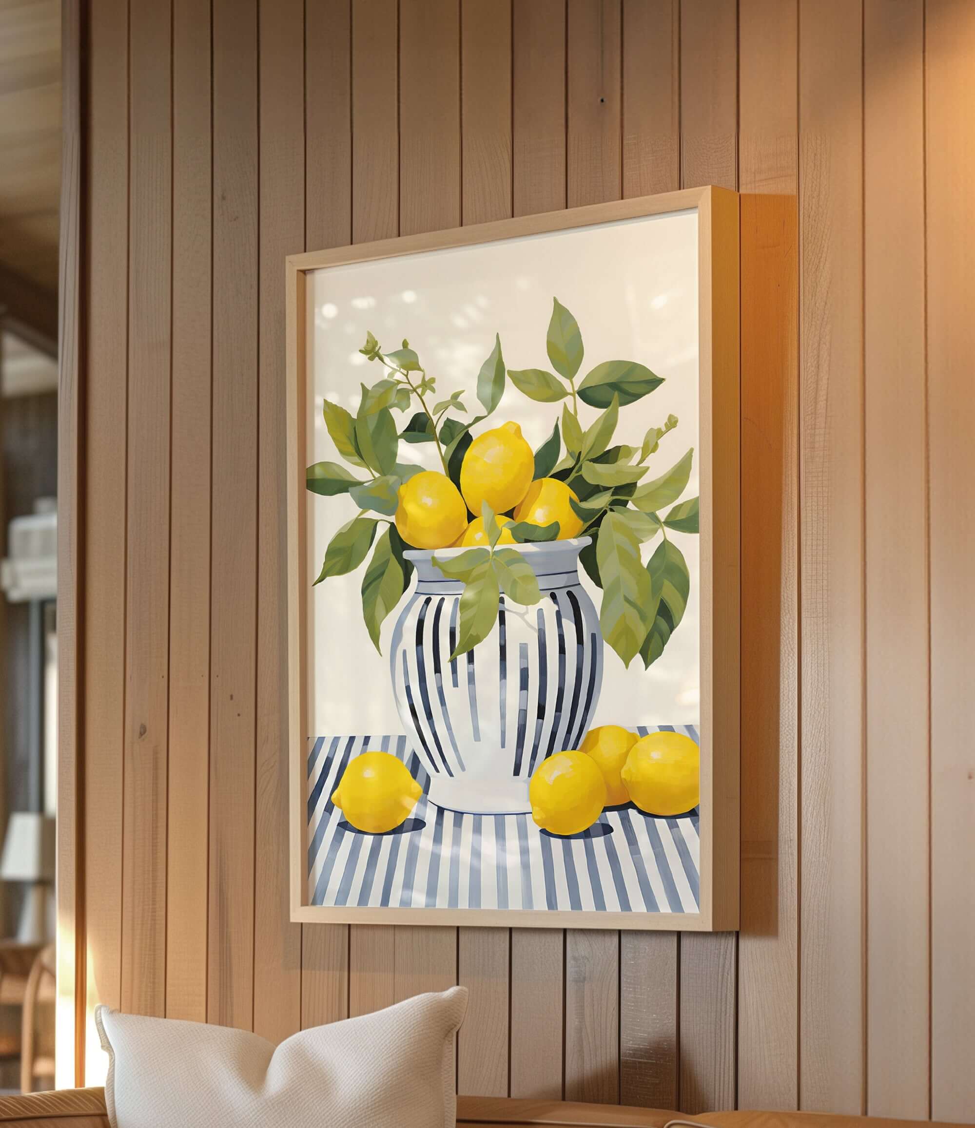 A framed painting of a vase filled with lemons and green leaves is hanging on a wooden wall.
