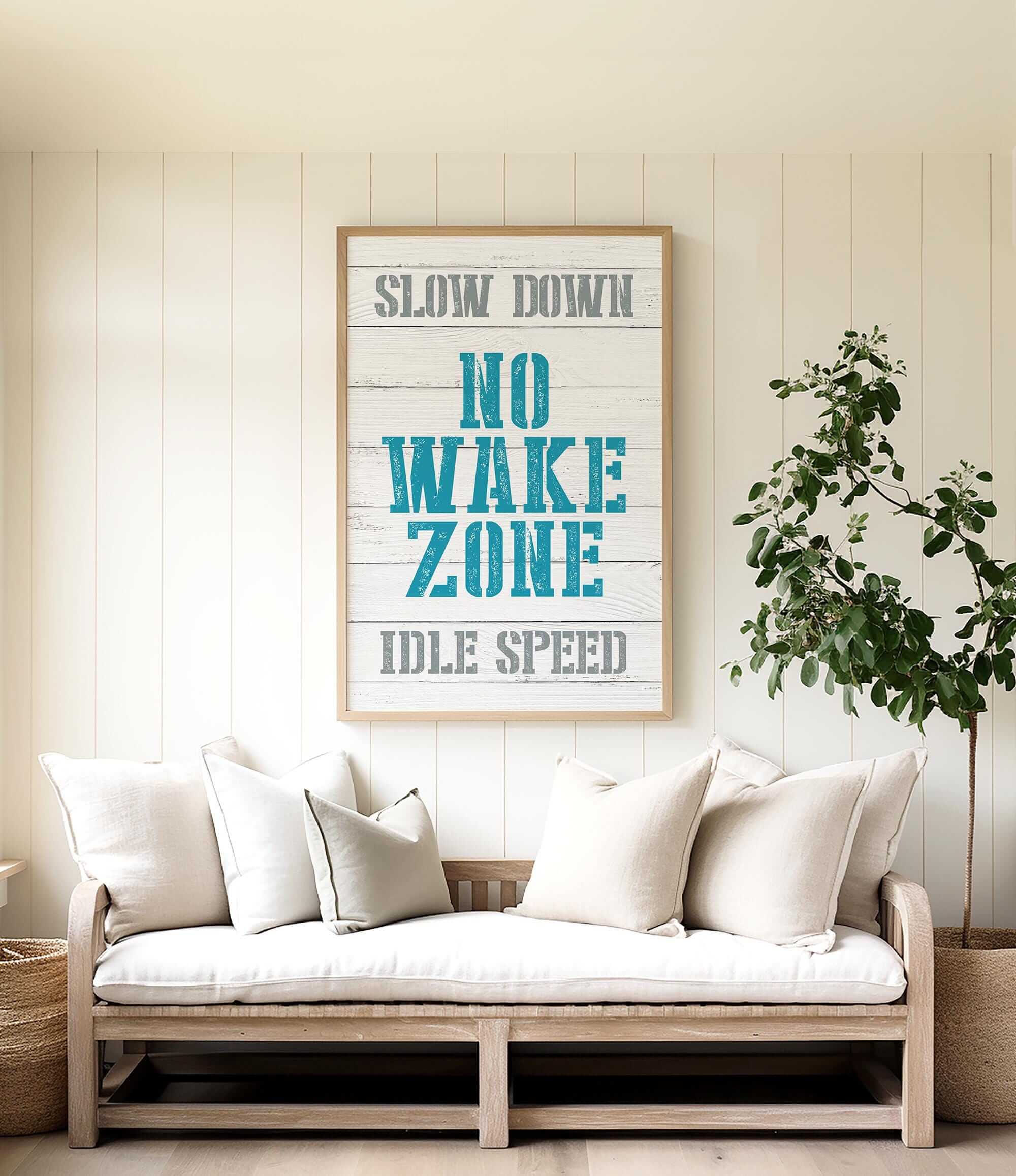 a living room with a white couch and a poster on the wall