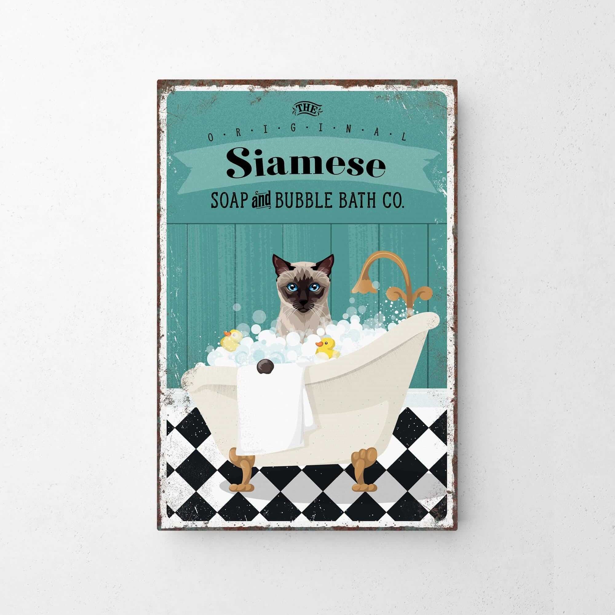 A vintage-style poster advertising Siamese Soap and Bubble Bath Co., featuring a Siamese cat sitting in a bathtub filled with bubbles.