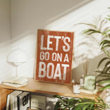 a wooden sign that says let&#39;s go on a boat