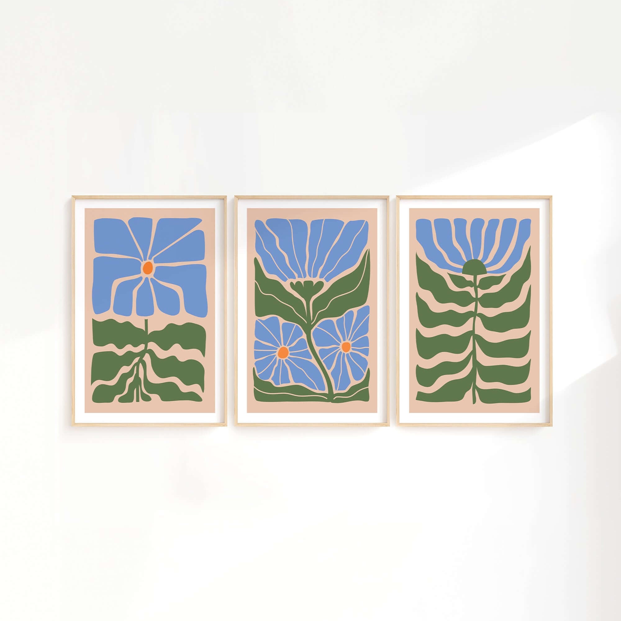The Flower Blocks Triptych | Set of Three Prints | 009 showcases framed abstract floral art with blue flowers and green stems, ideal for enhancing home decor and looking stunning against a white wall.