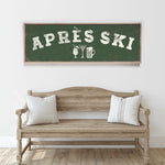 a wooden bench with two pillows, and above it is a green sign with white text that says "APRÈS SKI".