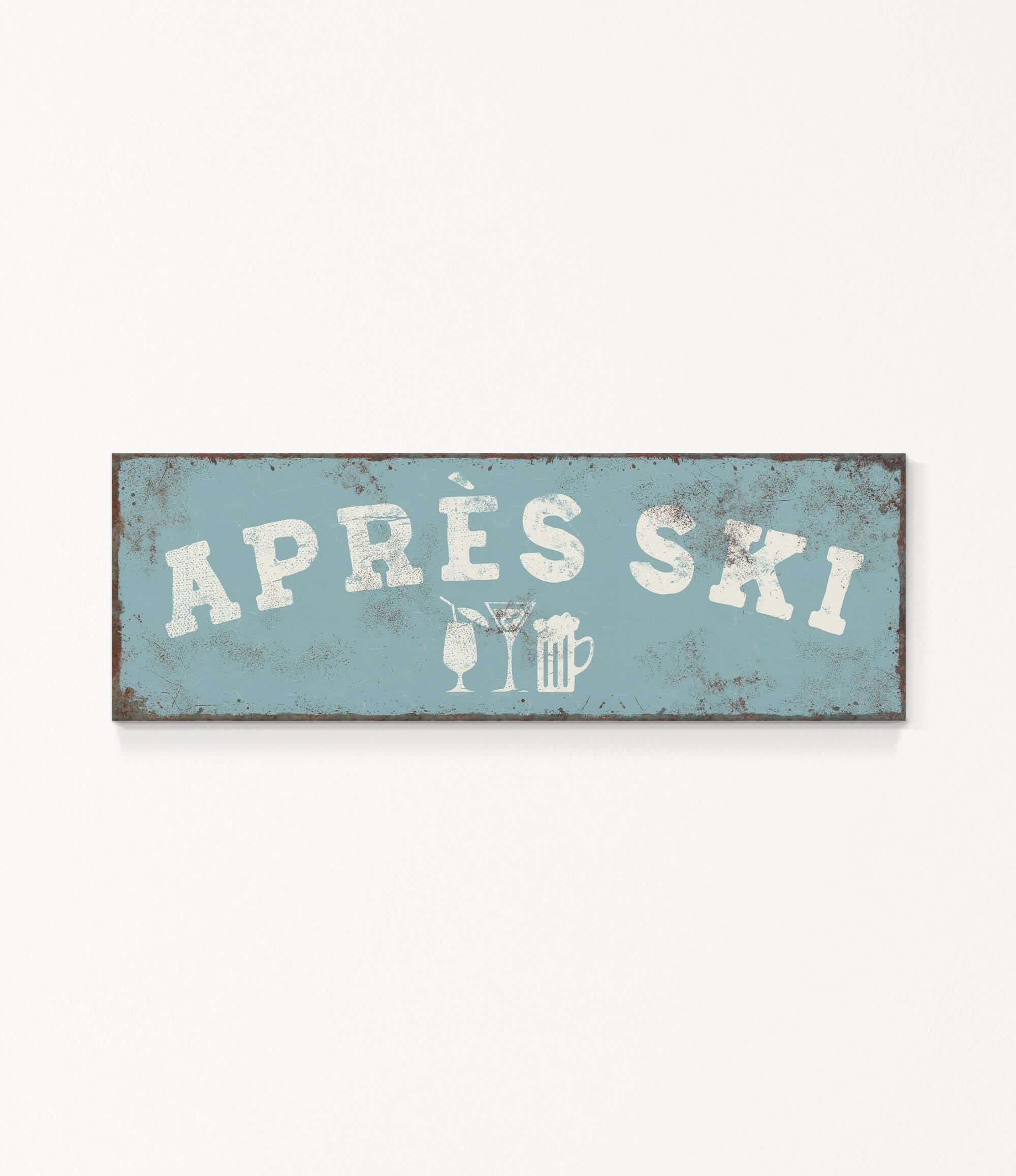 A weathered sign with the text "APRÈS SKI" in white letters, along with icons representing a beer and a martini glass.