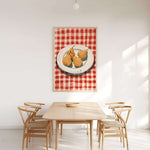 a dining room with a wooden table and four chairs, all facing a large painting of a plate of pears hanging on the wall above the table.