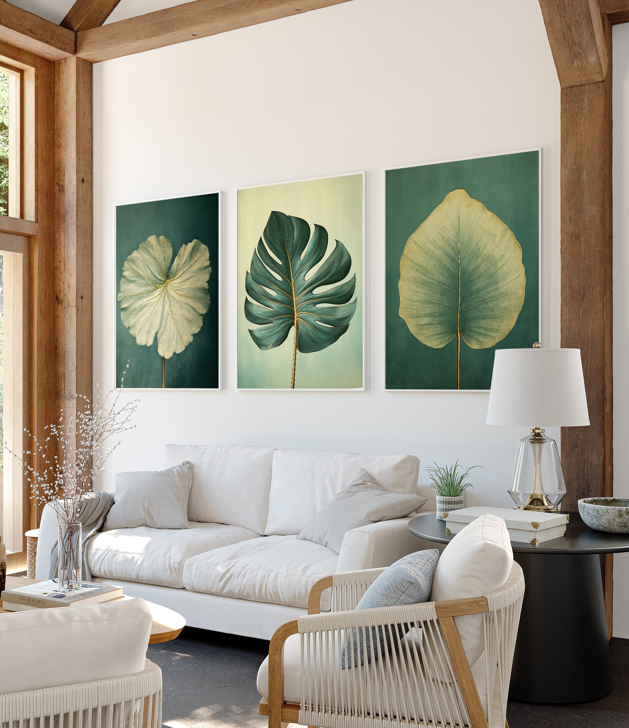 a modern living room with a white sofa, a coffee table, and three framed prints of tropical leaves on the wall.