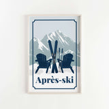 A framed print featuring a pair of blue Adirondack chairs with skis and poles, set against a snowy mountain backdrop.