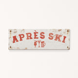 A weathered sign with the text "APRES SKI" in red letters, along with icons of a beer mug and a martini glass, indicating a location or establishment related to skiing and alcoholic beverages.