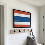 a wooden bench with a bag and coat rack