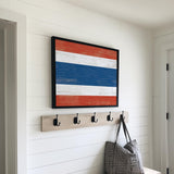a wooden bench with a bag and coat rack