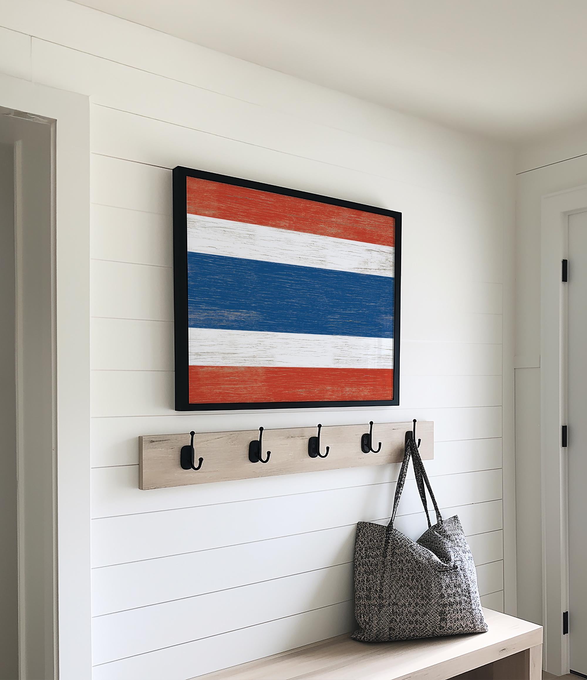 a wooden bench with a bag and coat rack