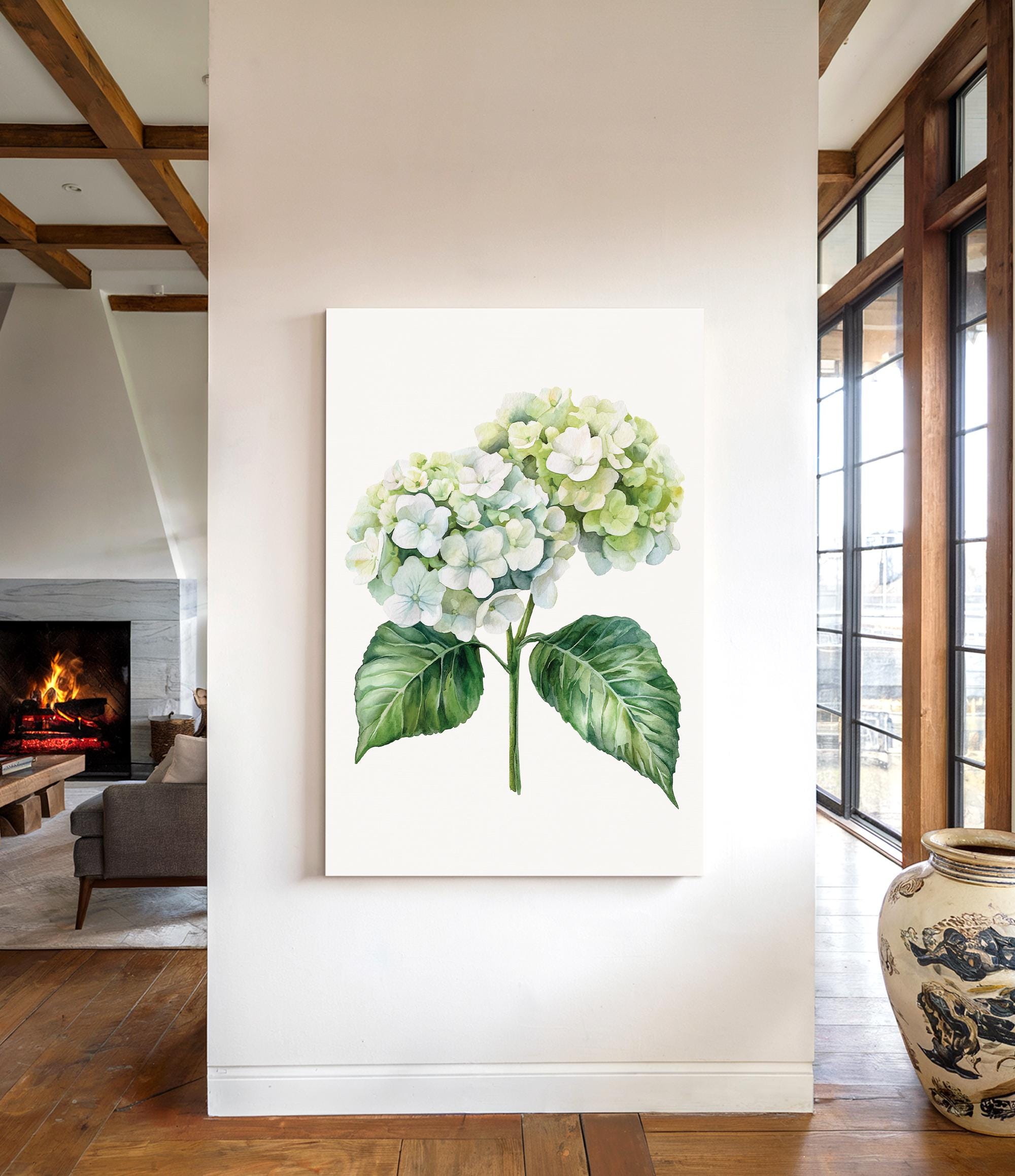 a large white canvas hanging on a wall, depicting a watercolor painting of a hydrangea flower with green leaves.
